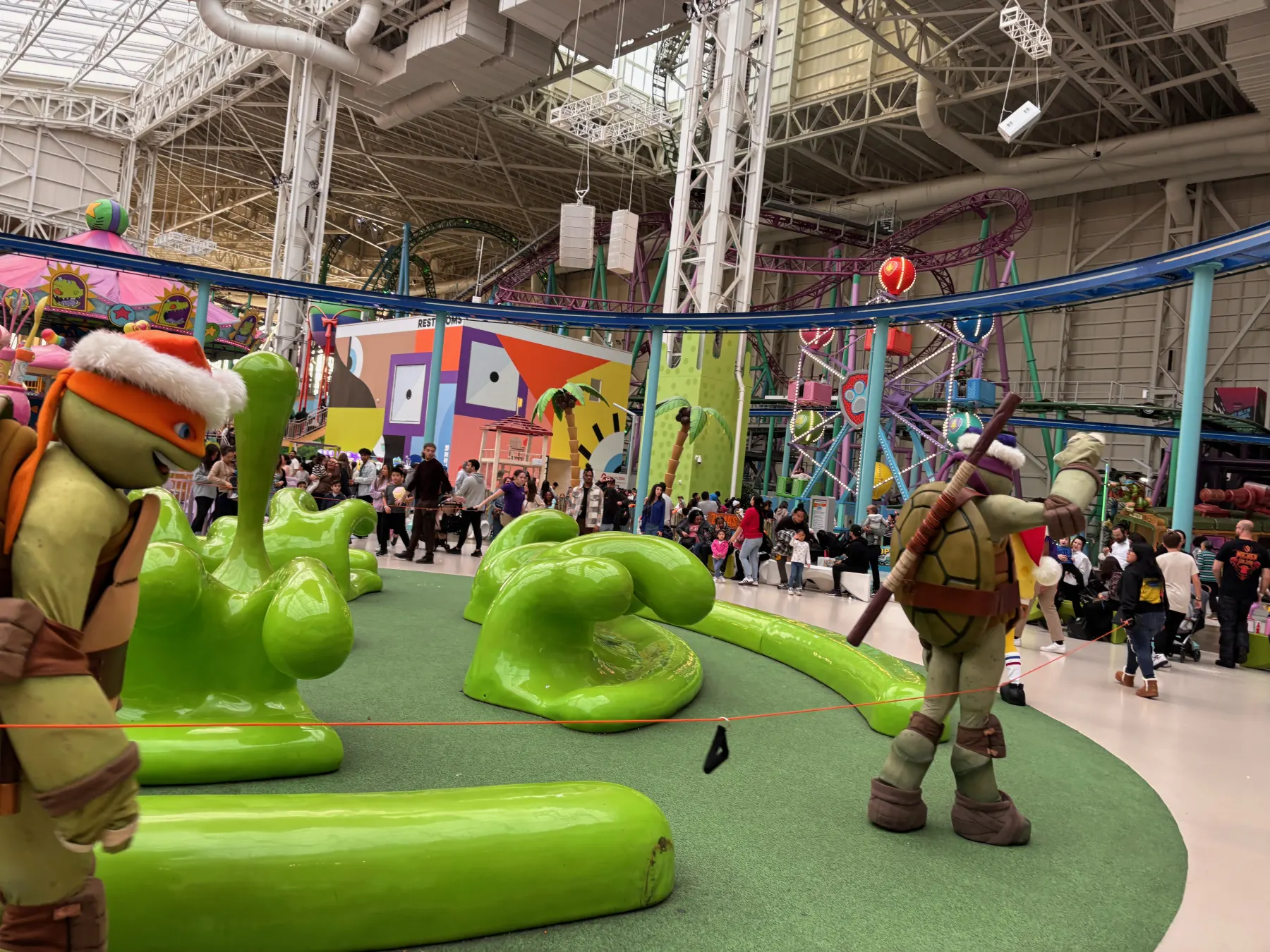 Indoor play area with colorful child-sized activity structures.
